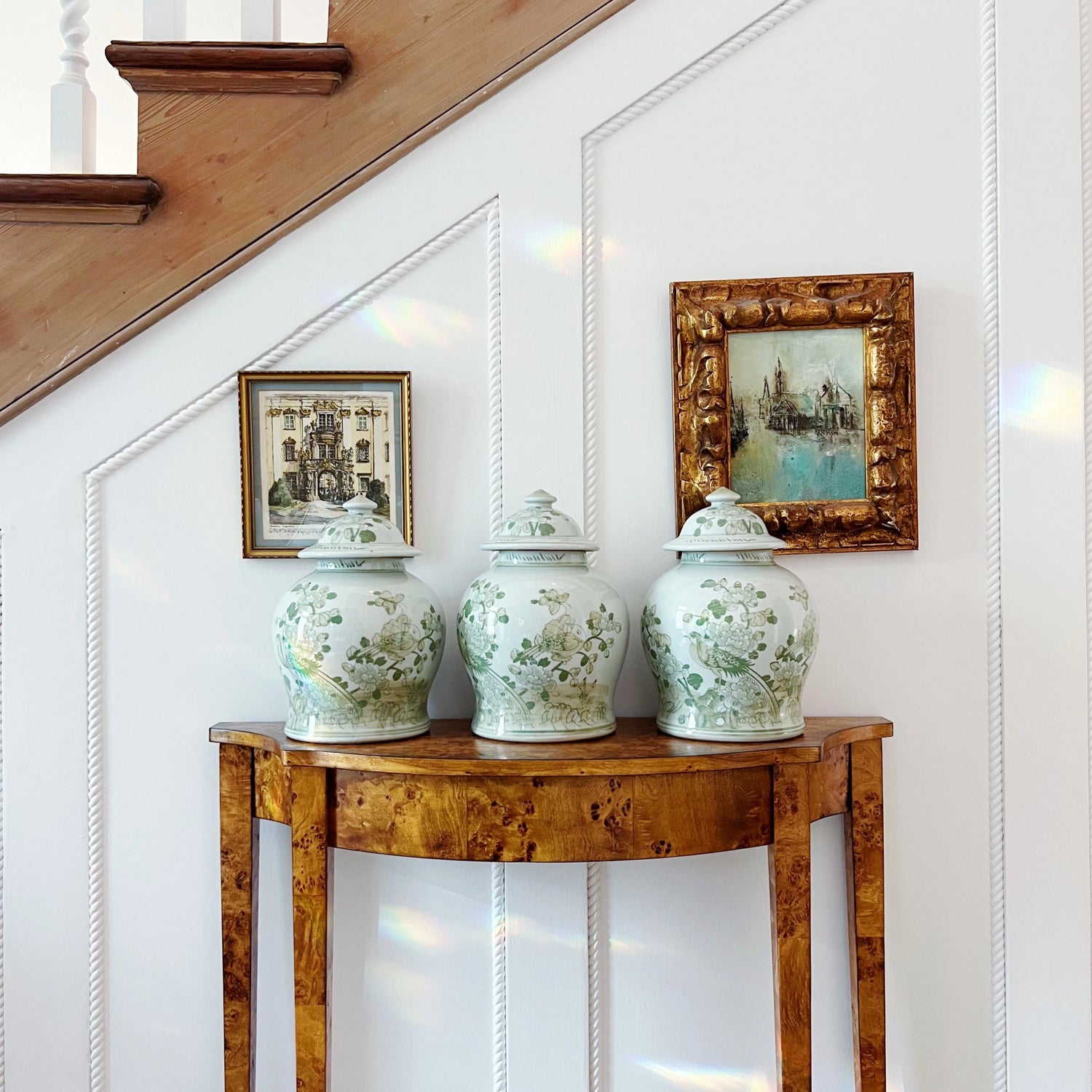 green and white hand painted temple jars on a wooden table with vintage framed art styled by House of Modern Vintage