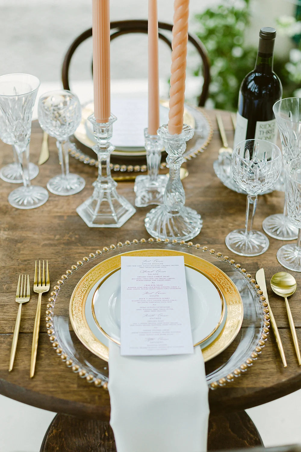 seated dinner with glass candle stick holders and floral society taper candles and vintage crystal wine glasses