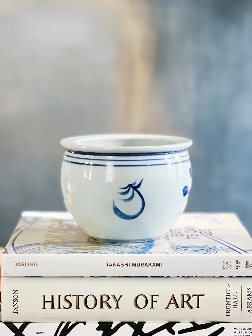 blue and white fishbowl planter