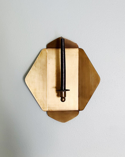 brass wall sconce with black taper candle 