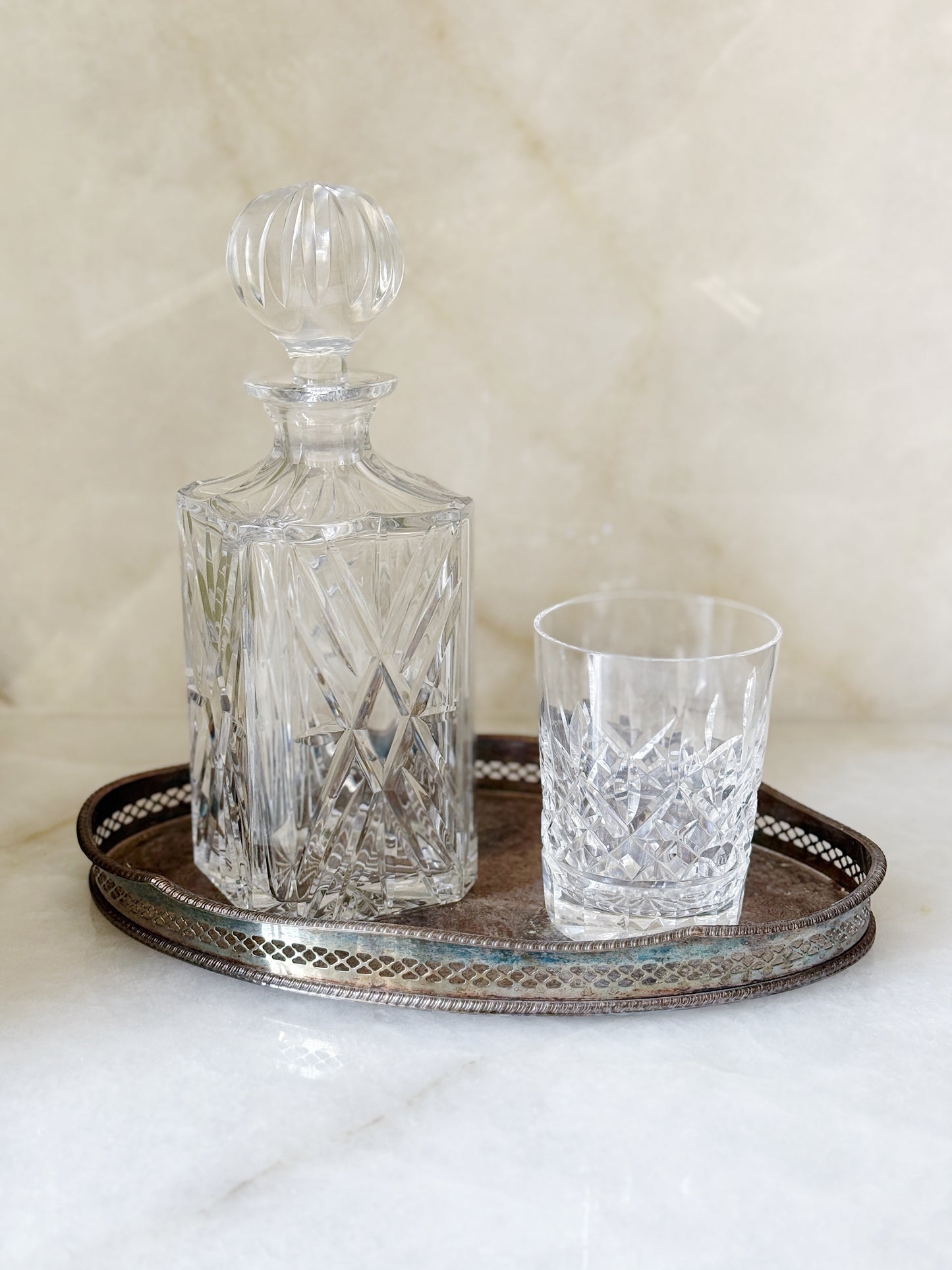 Vintage Crystal Decanter with Waterford crystal tumbler on an antique silver serving tray