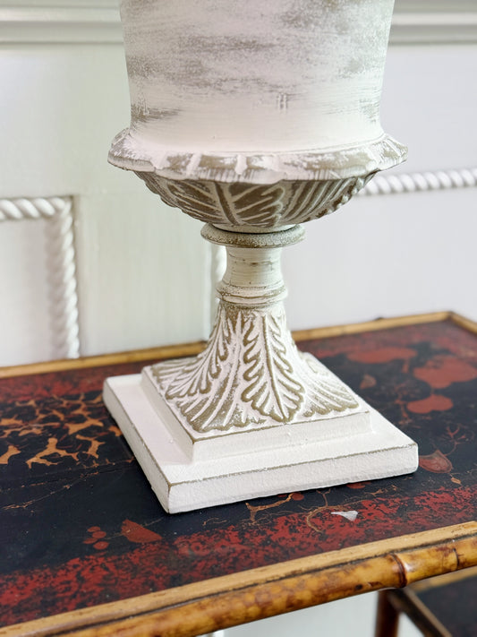 White washed garden urn on vintage bamboo table