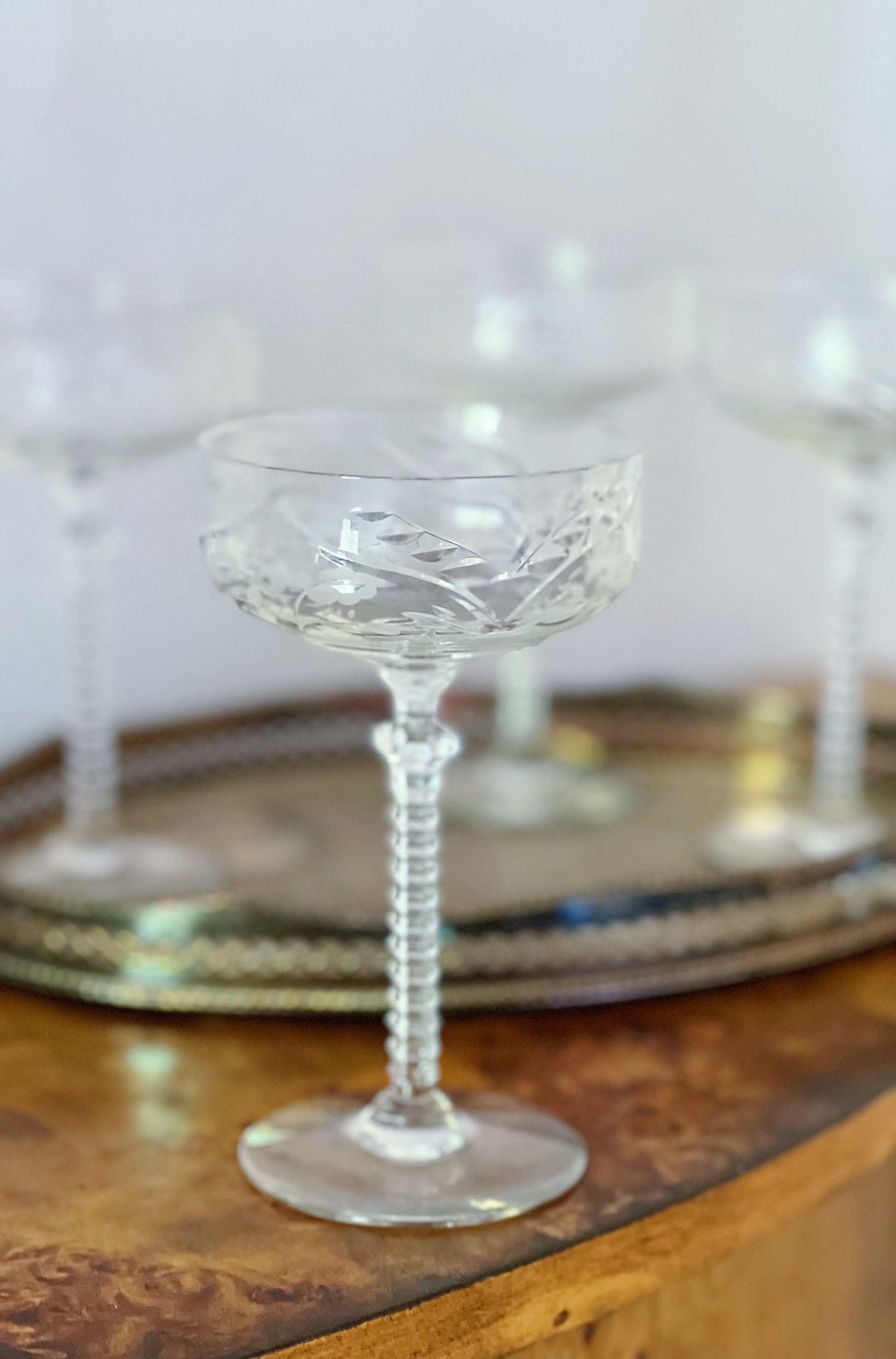 vintage etched champagne coupes on a vintage brass tray 