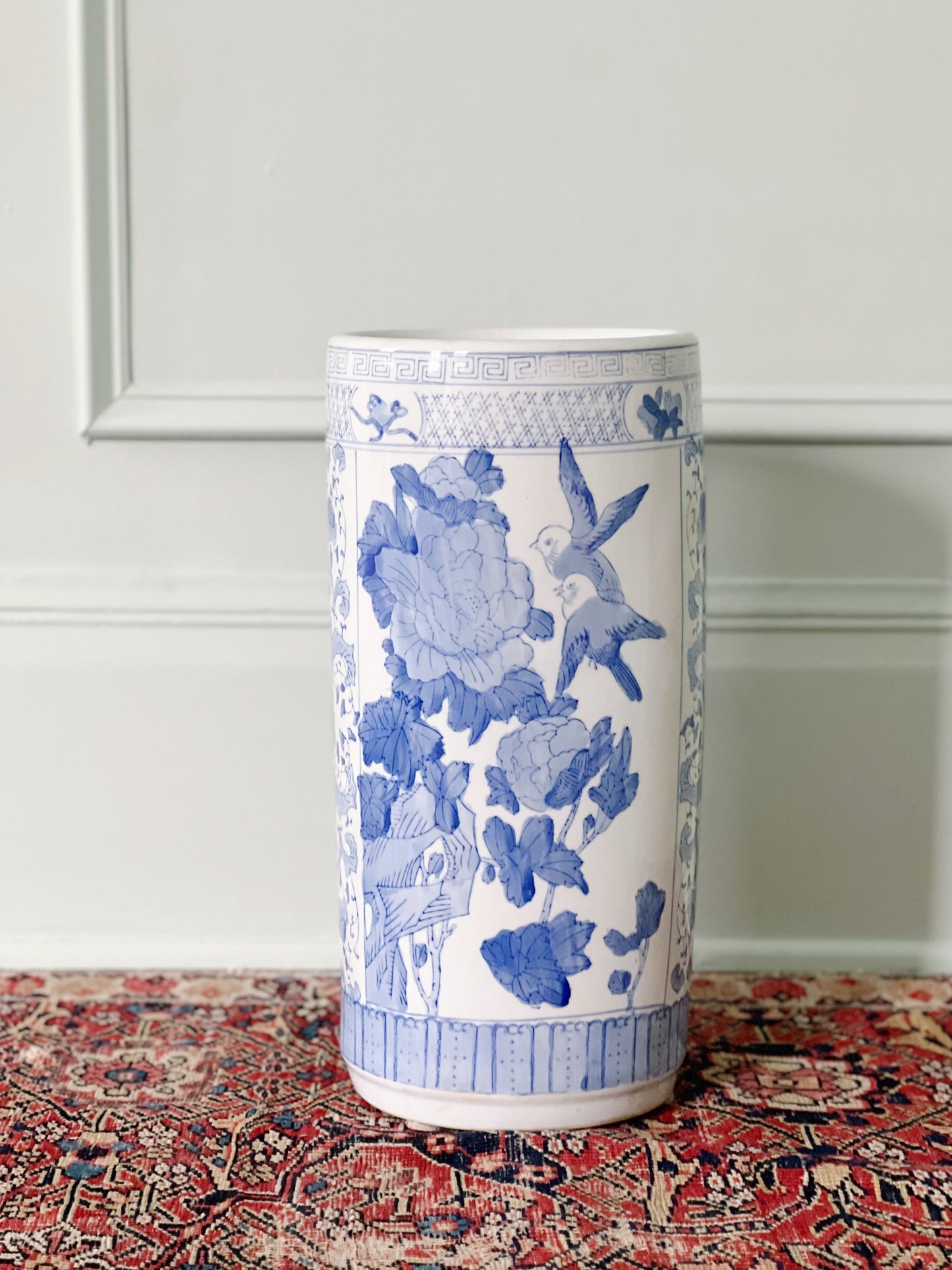 vintage blue and white willow ware umbrella stand on a vintage rug