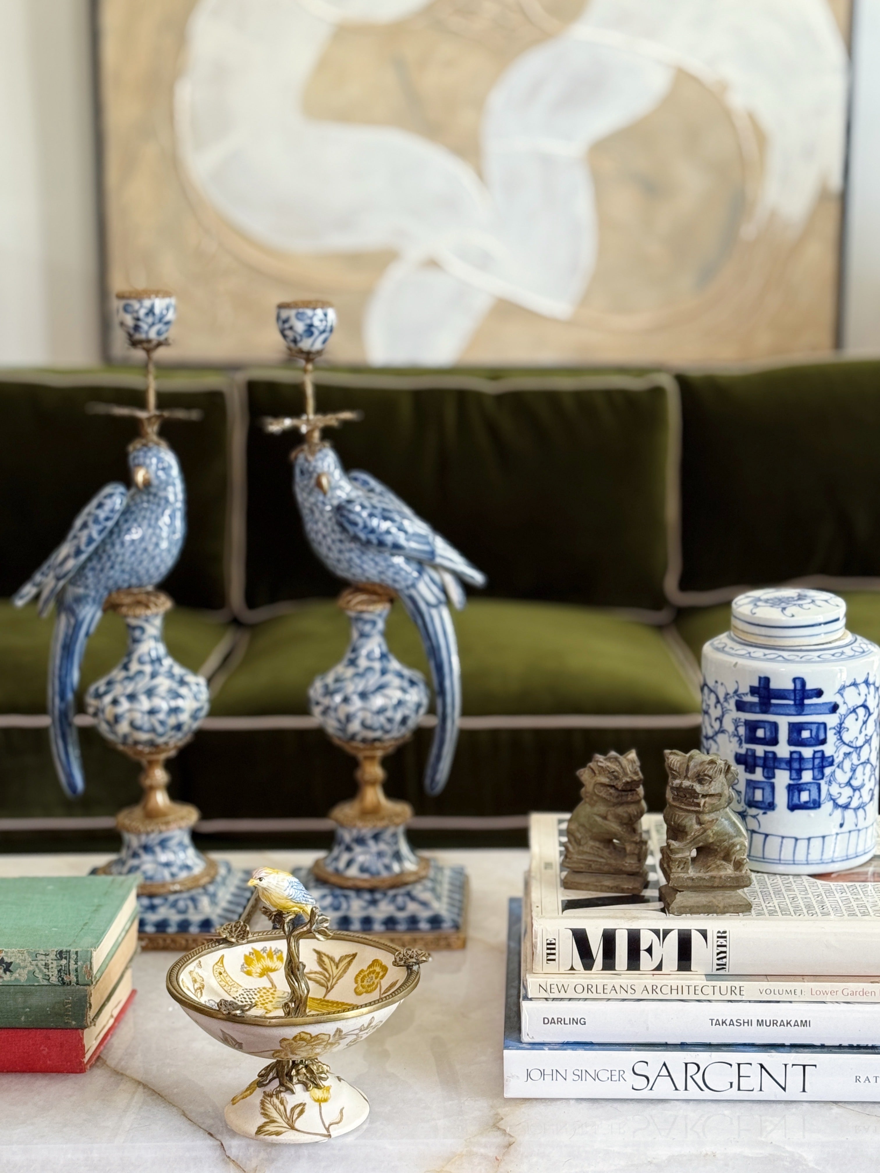 living rom styled with vintage home decor including blue and white chinoiserie bird candle sticks and ginger jars house of modern vintage, vintage books and antique foo dogs