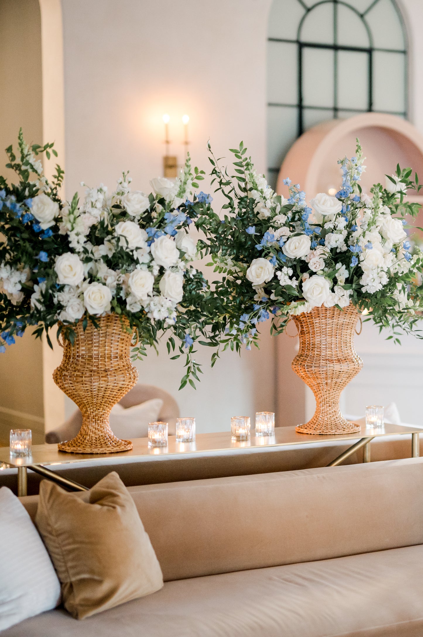 wicker garden urns filled with flowers at a party