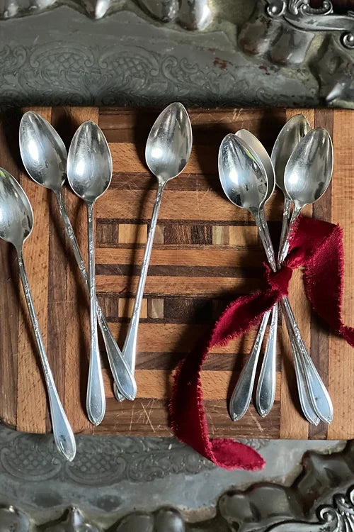 antique silver tea spoons wrapped in a red velvet bow