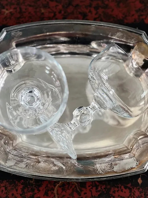 vintage crystal champagne coupes on an antique silver serving tray 