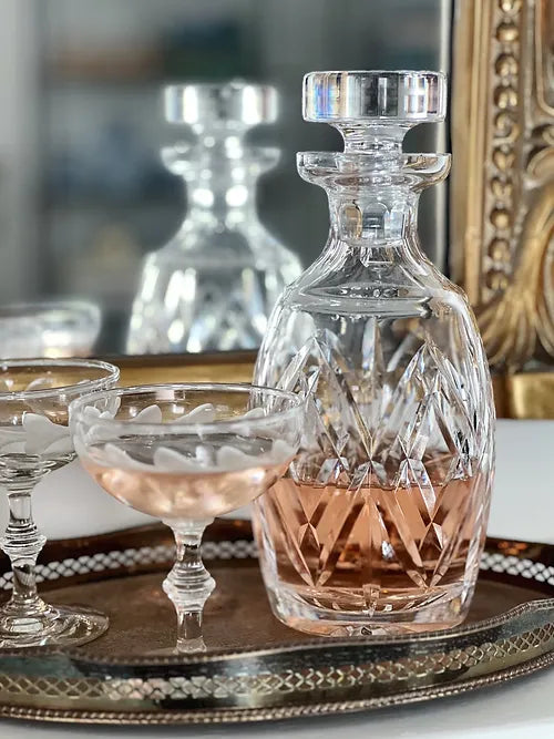 vintage crystal decanter and vintage champagne coupes