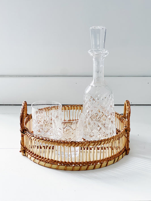 vintage waterford crystal decanter and double old fashioned glasses in a wicker tray 