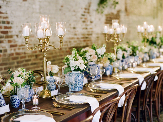 Timeless wedding reception featuring vintage blue and white chinoiserie centerpieces, brass candelabras, antique wood tables, and vintage crystal glassware.
