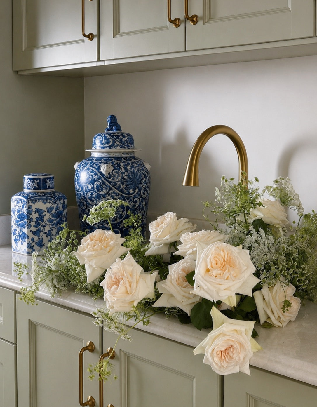 blue and white chinoiserie ginger jars, home decor and dinnerware and fresh flowers in a remodeled kitchen