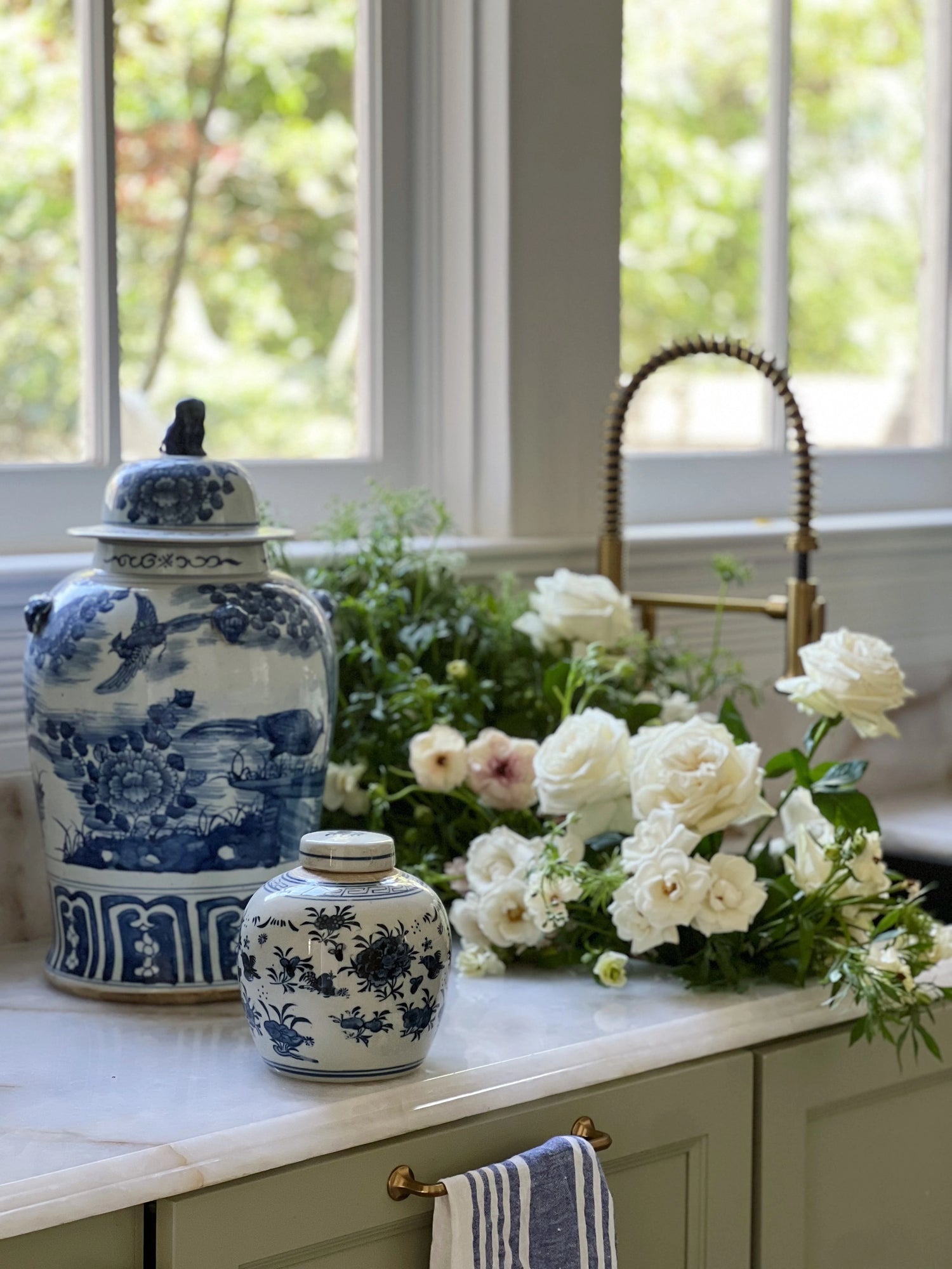 blue and white handprinted ginger jars and fresh flowers in a remodeled kitchen