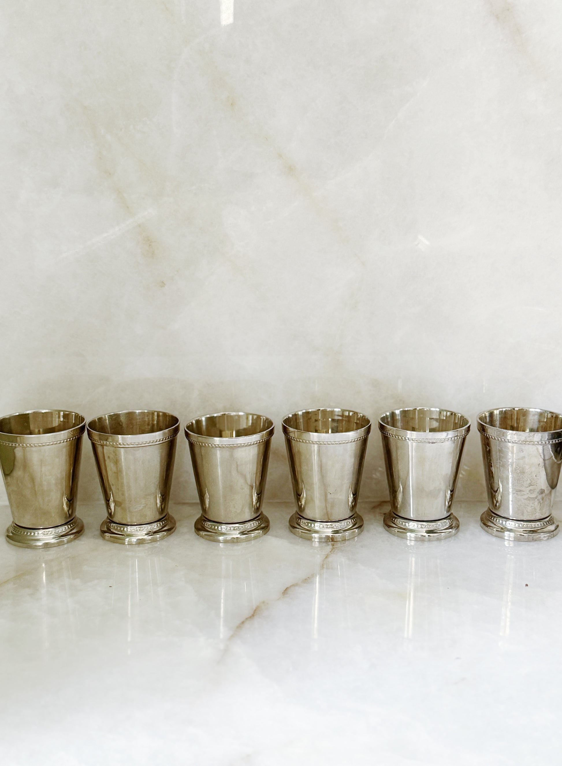 Vintage silver mint julep cups on an antique serving tray
