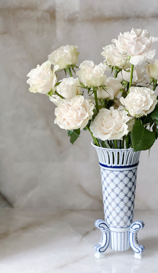 vintage blue and white porcelain pedestal vase with white roses 