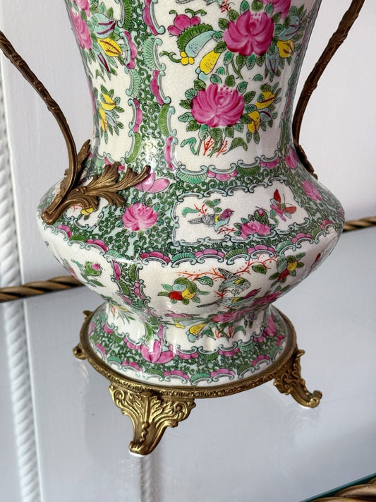 Close-up of the rose medallion pattern and bronze handle on the vase