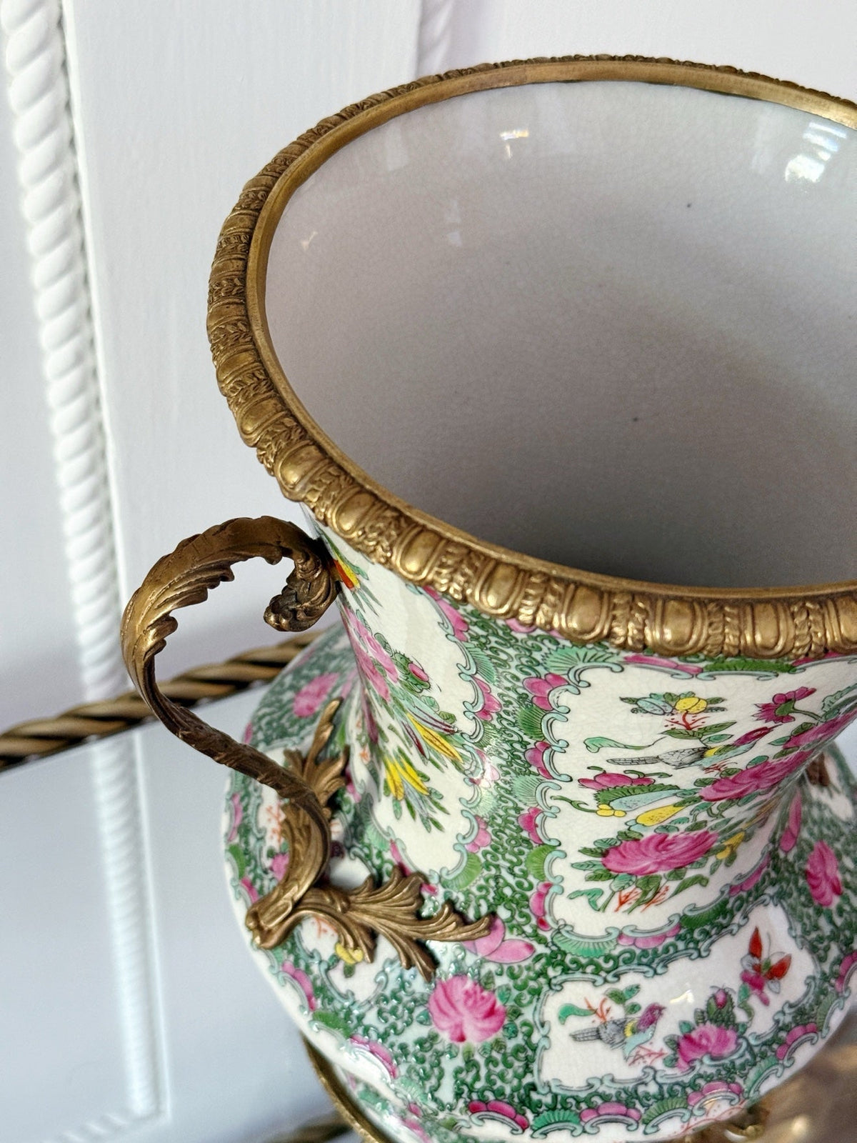 Close-up of the bronze rim and handle on the rose medallion vase