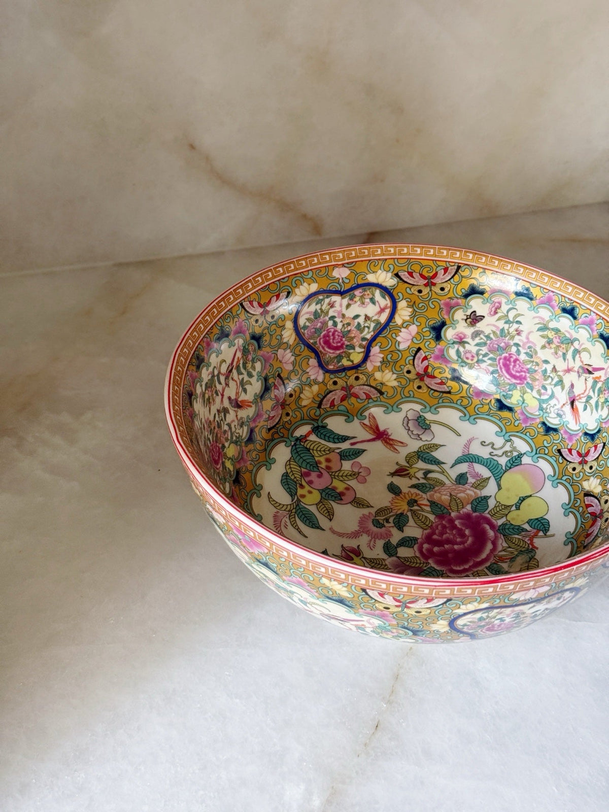 Close-up of the floral and butterfly detail inside the bowl