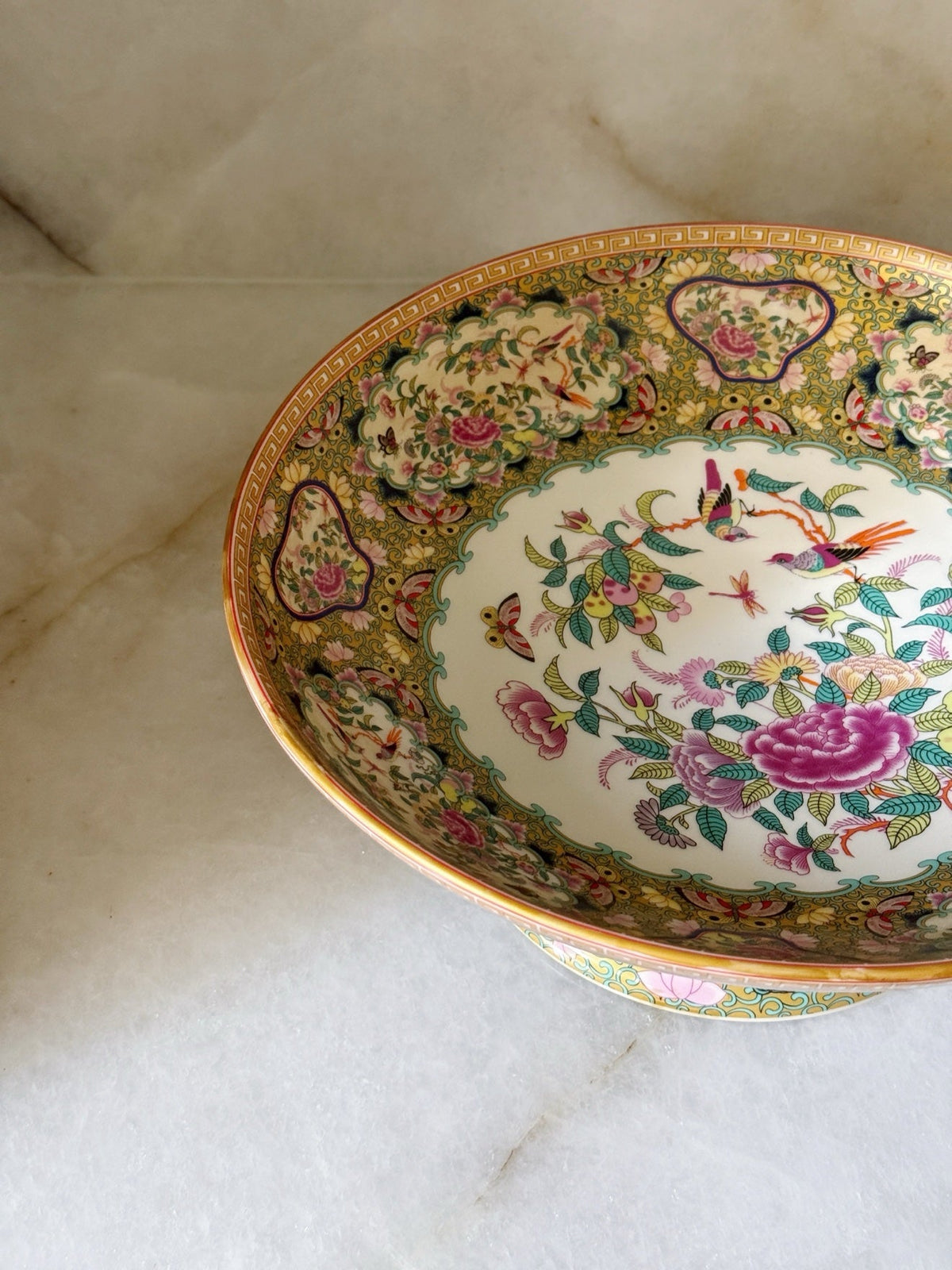 Close-up of the floral and bird detail inside the pedestal bowl