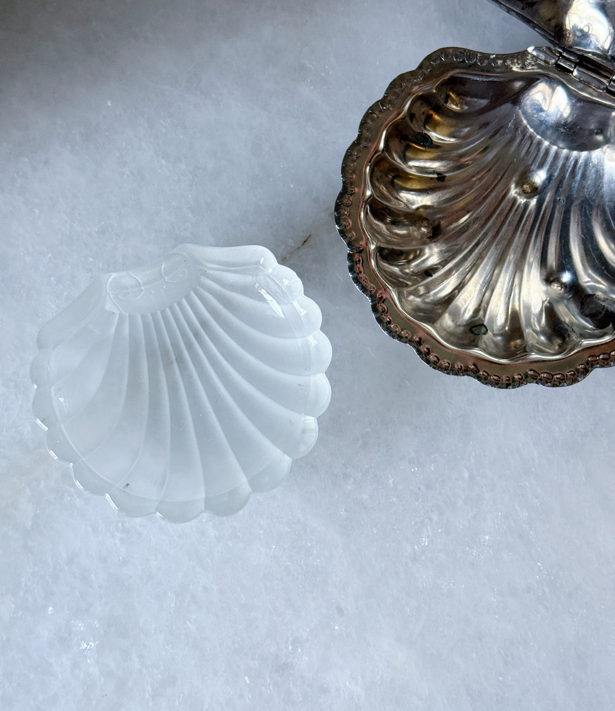 Glass insert removed beside the vintage silver clamshell caviar dish