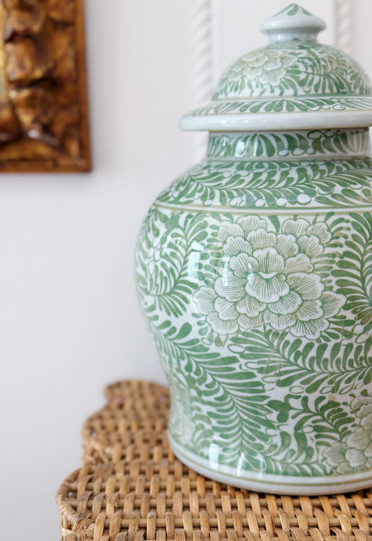 green and white porcelain temple jar with floral design 