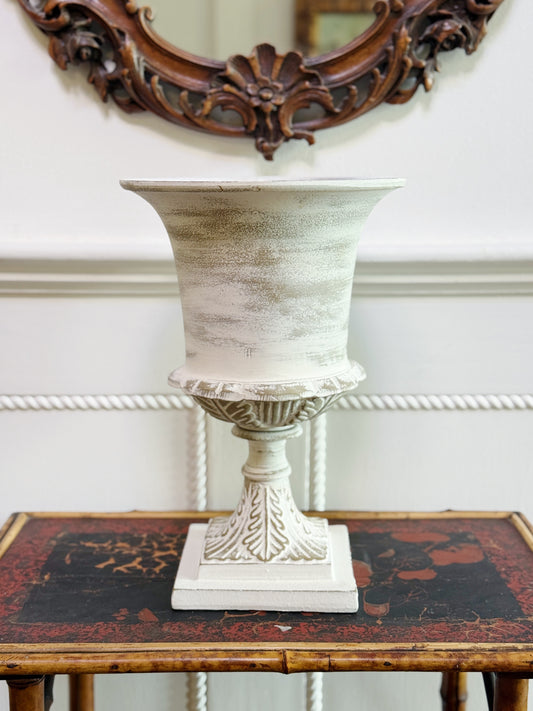 White washed garden urn on vintage bamboo table 