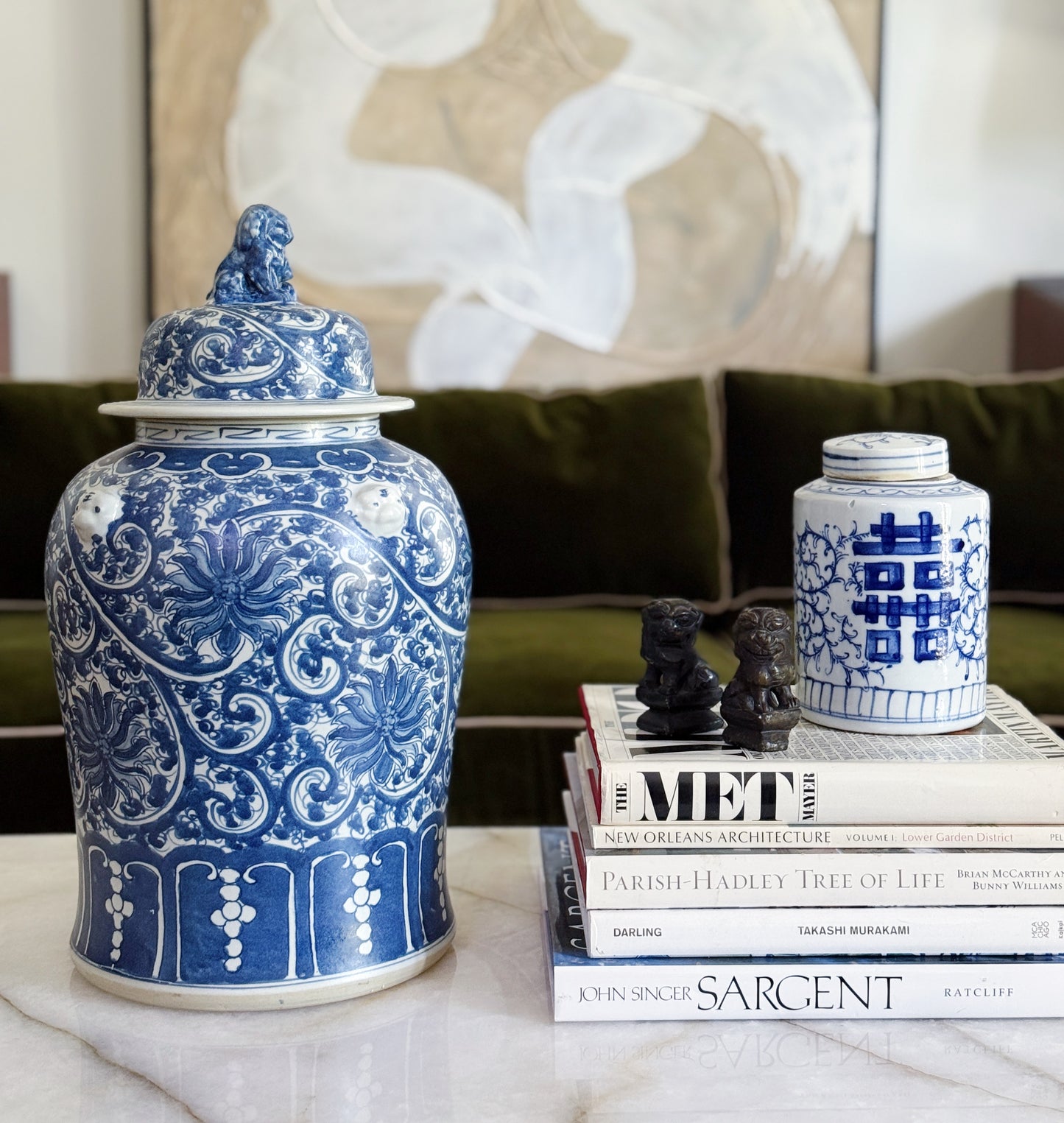 Large Blue & White Chinoiserie Scrolling Lotus Temple Jar On vintage coffee table books in a traditional decor home 