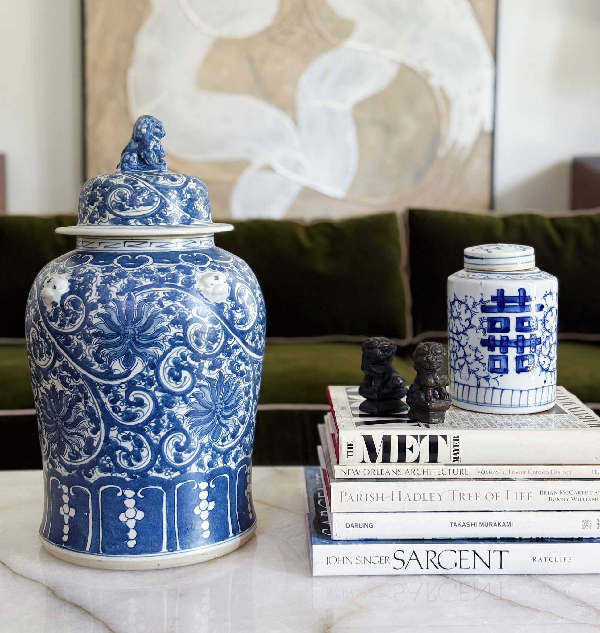 Large Blue & White Chinoiserie Scrolling Lotus Temple Jar On vintage coffee table books in a traditional decor home 