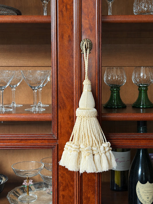 Ivory Decorative Tassel Shown on an antique glass front cabinet