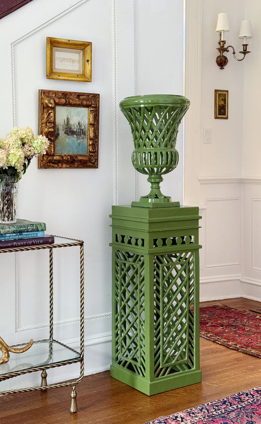 English Garden Fretwork Urn and Pedestal Set in Pistachio Green styled in a traditional foyer with vintage artwork, brass side table, decorating books, and hydrangeas.
