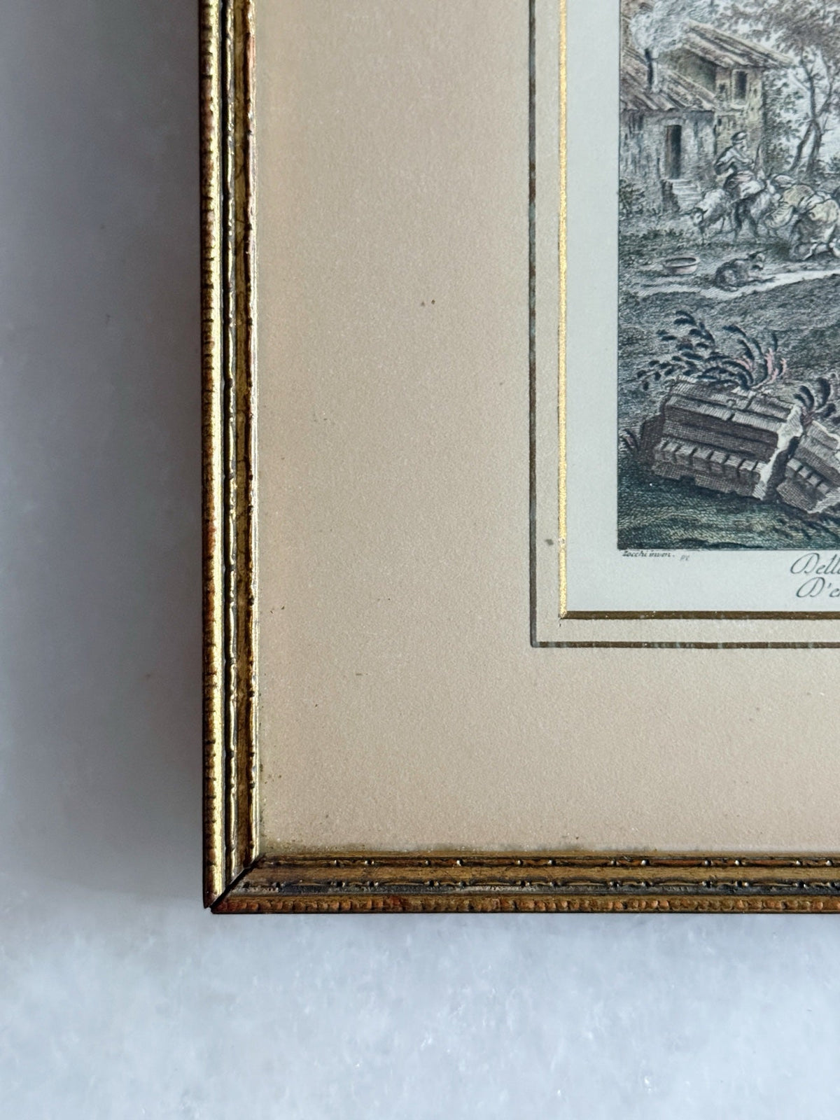 Close-up of the gilt frame corner with beaded molding