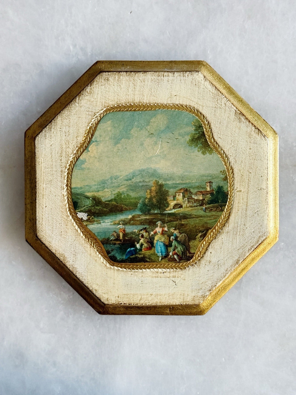 Octagonal Florentine framed print with a pastoral river scene