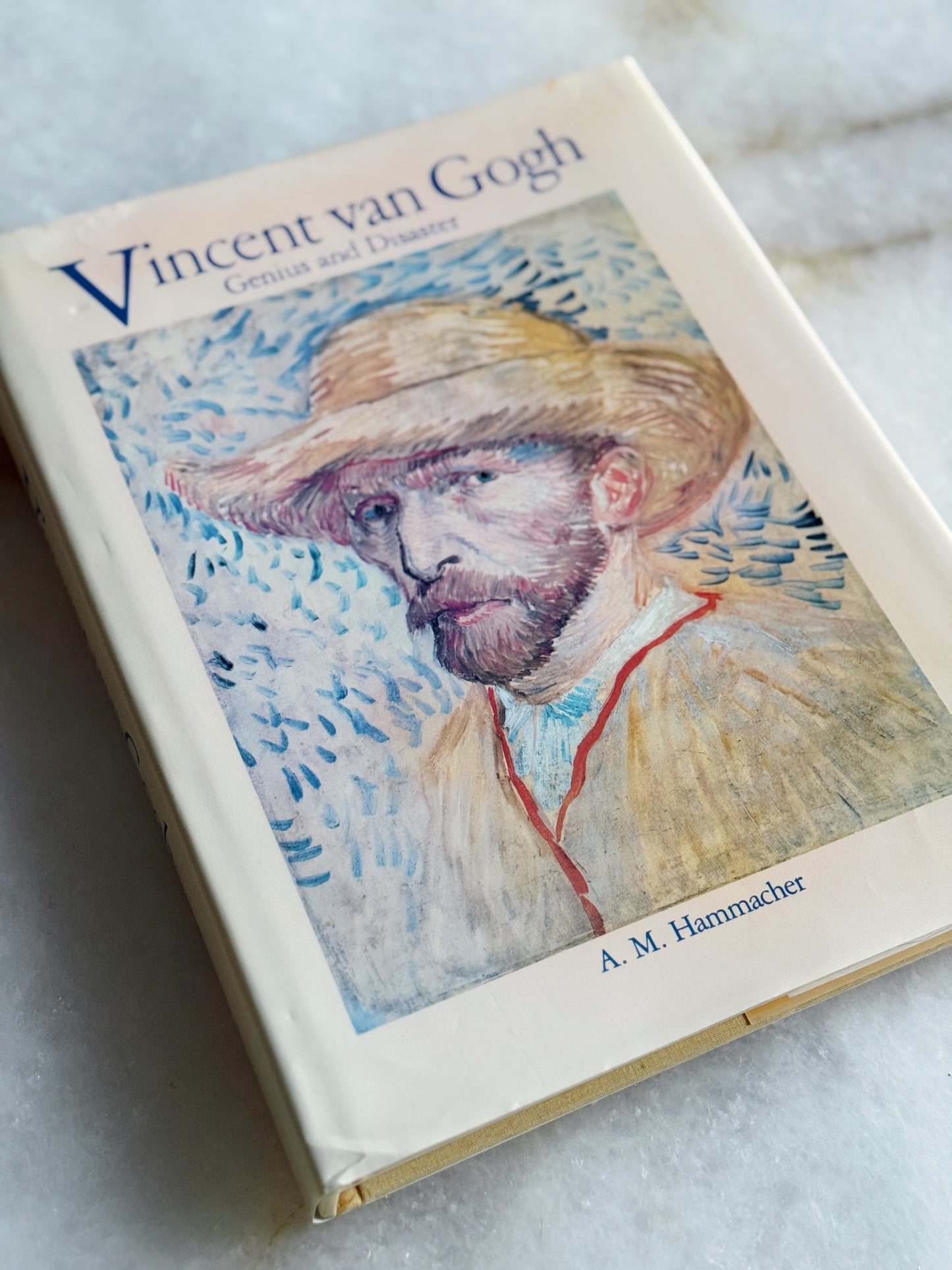 Vintage coffee table Book titled 'Vincent van Gogh: Genius and Disaster' by A. M. Hammacher on a textured surface