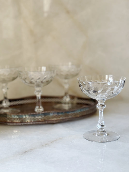 Vintage Laurel Wreath Champagne Coupes Sitting on a vintage silver serving tray