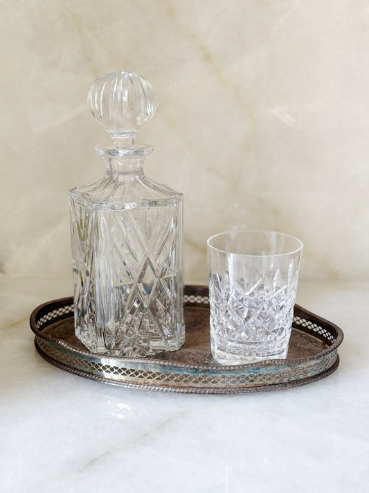 Vintage Crystal Decanter with Waterford crystal tumbler on an antique silver serving tray 