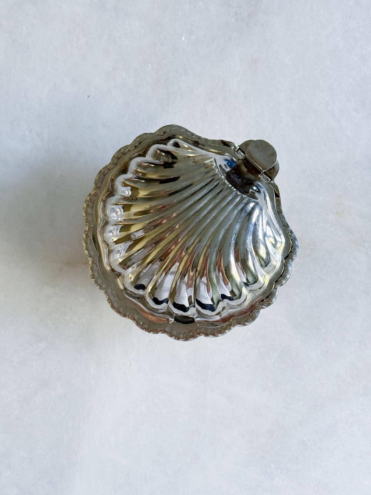 Vintage silver clamshell caviar dish closed, top view