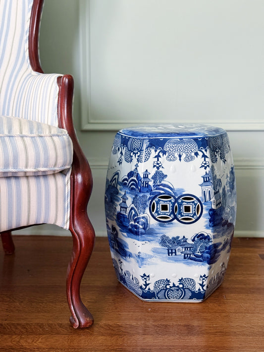 blue and white willow ware porcelain garden seat next to an antique chair 