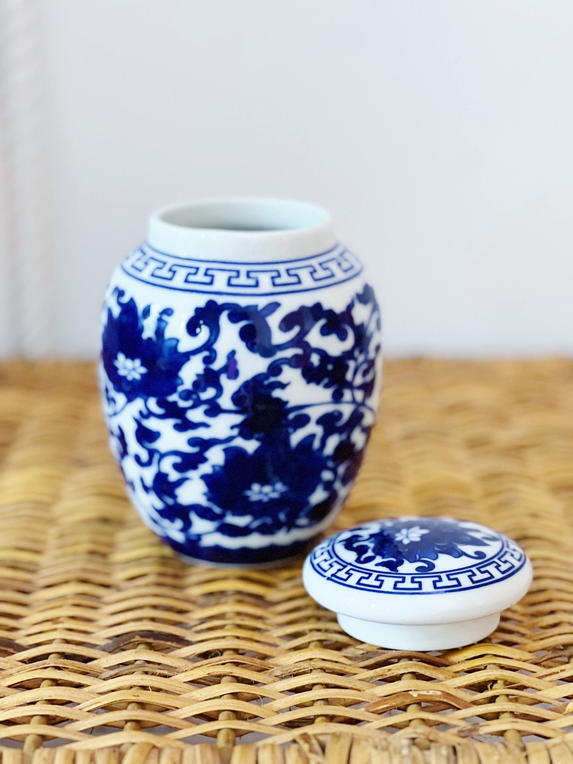 Blue and white willow ware ginger jars on a wicker table 