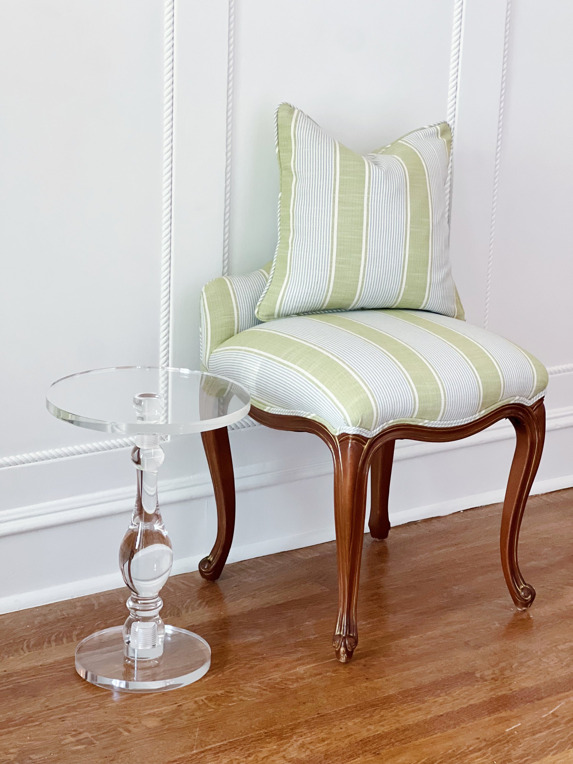 custom pillow in Kravet Barbour stripe in pear on a matching vanity stool and acrylic side table 