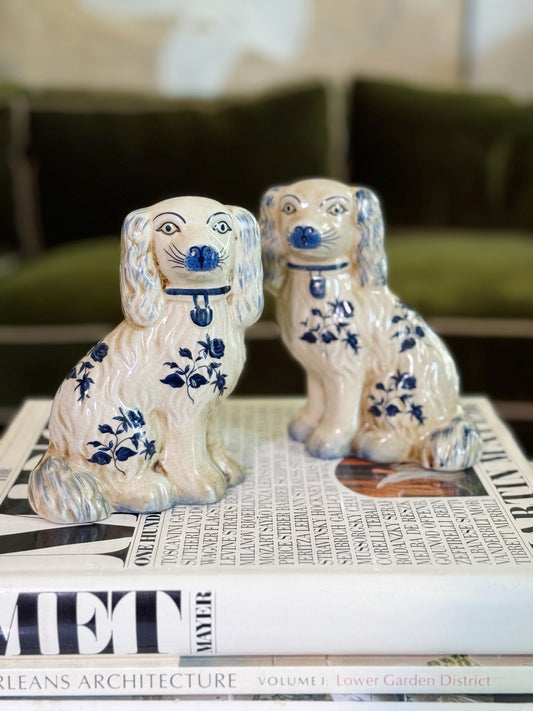 Pair of blue and white floral Staffordshire spaniel dogs styled on stacked coffee table books