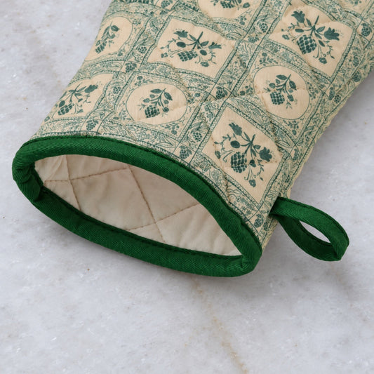 Quilted green botanical print oven mitt, angled view