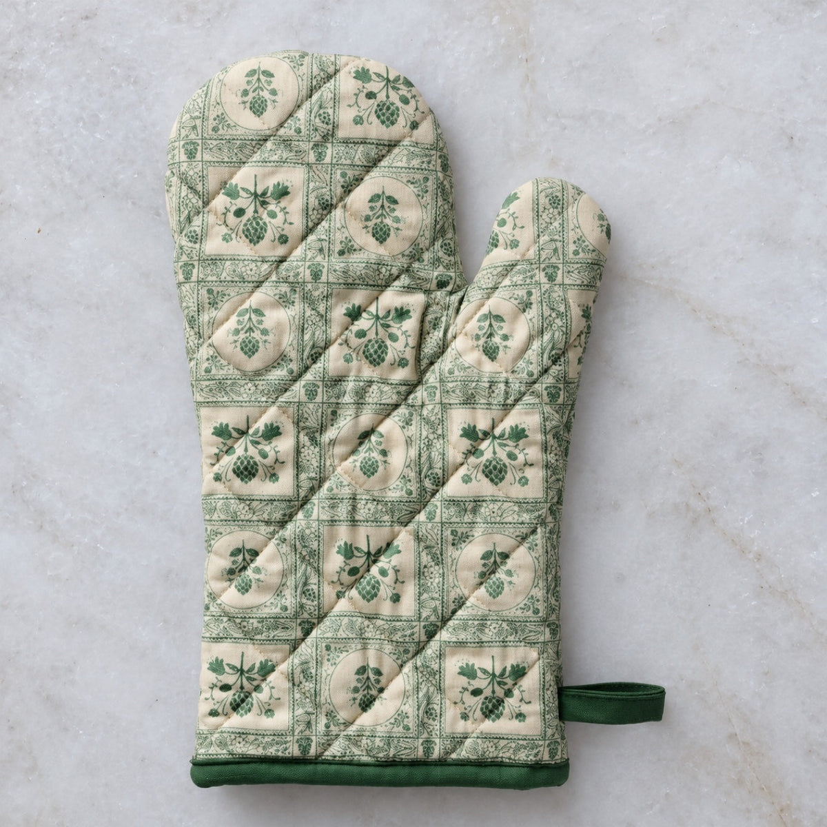Quilted green botanical print oven mitt, flat view