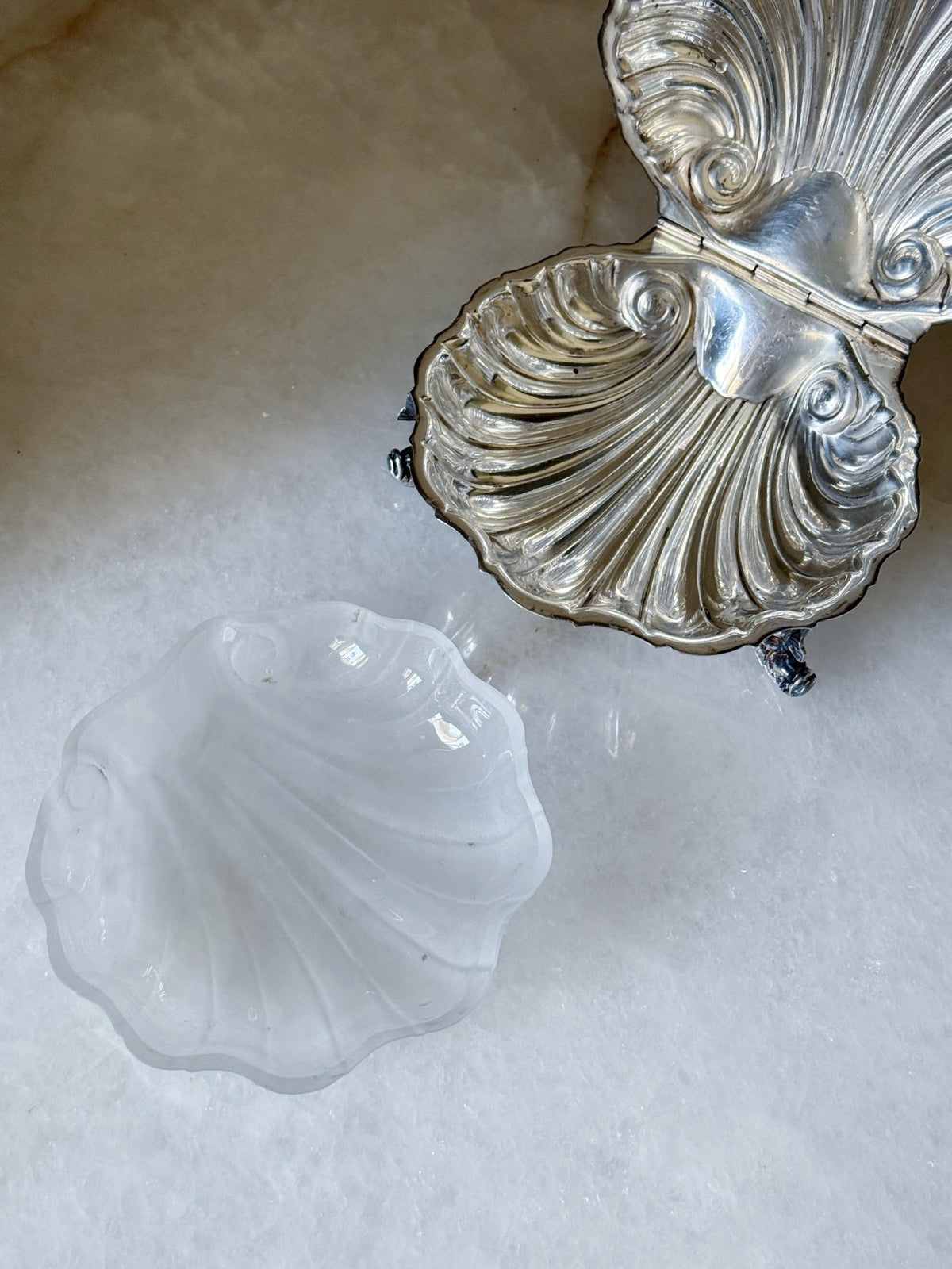 Close-up of the ornate shell detailing on the vintage silver caviar dish