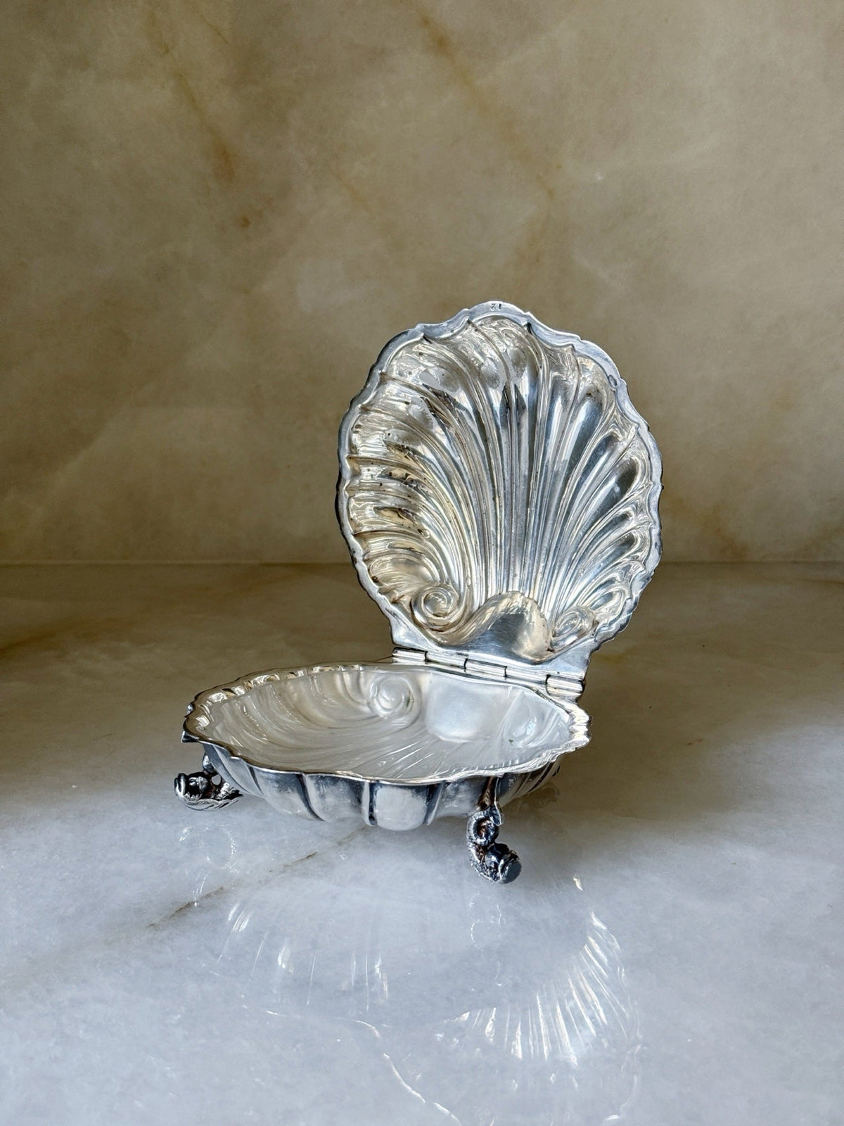 Ornate vintage silver footed shell caviar dish open, front view