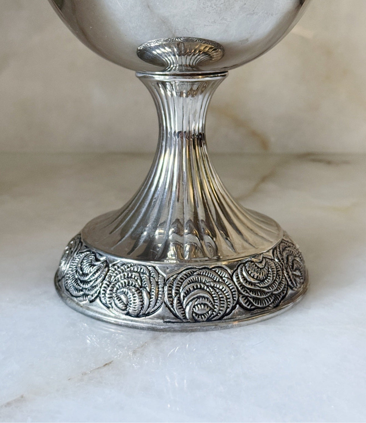 Close-up of the pedestal base on the vintage silver urn