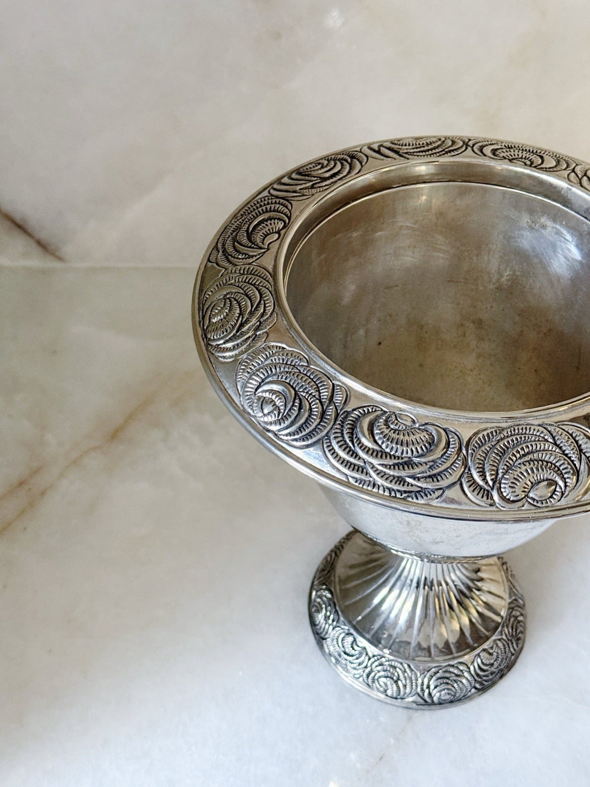 Top view of the rosette rim on the vintage silver pedestal urn