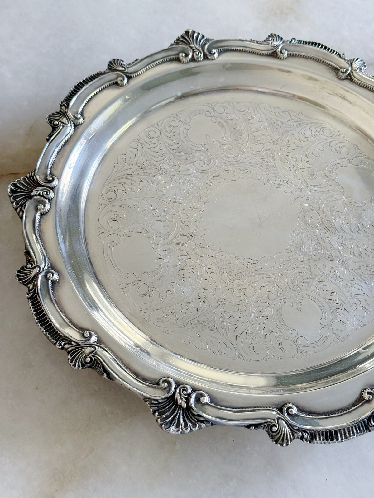 Close-up of the scrolling border on the vintage silver serving tray