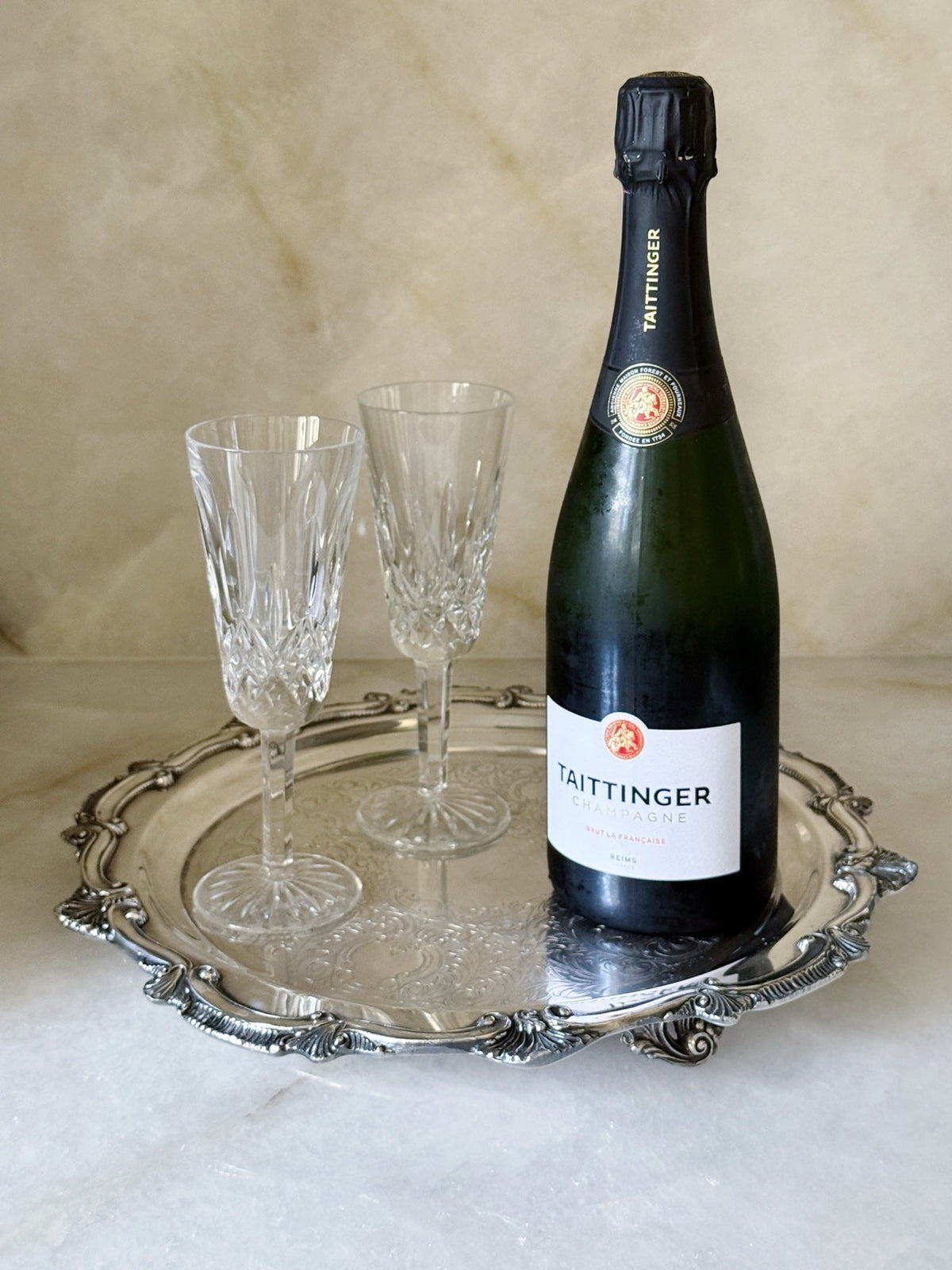Vintage silver footed serving tray styled with champagne and glasses