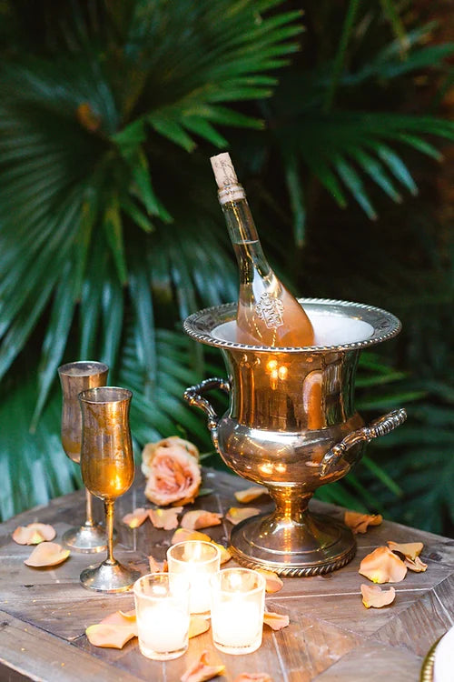 vintage silver champagne flutes with silver champagne bucket with bottle of wine
