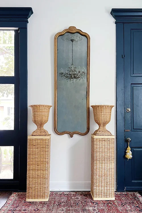 wicker urn and pedestals, New Orleans home decor, antique mirror, vintage brass and crystal chandelier, vintage rug